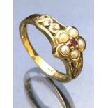 9ct Gold ring set with seed Pearls around a central garnet approx size 'M' and 2.6g