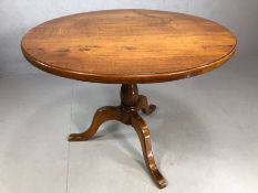 Circular wooden table on tripod feet, diameter approx 100cm