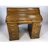 Antique roll-top desk, opening to reveal pigeon holes and drawers, pedestal provides four drawers