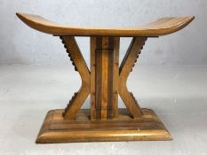 Hardwood stool in the style of a tribal headrest, made with mixed hardwoods, approx 55cm x 30cm x