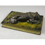 Paper weight depicting a Bulldog lying on a book!