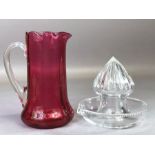 William Yeoward glass lemon squeezer and a cranberry glass jug with fluted rim, approx 14cm in