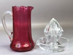 William Yeoward glass lemon squeezer and a cranberry glass jug with fluted rim, approx 14cm in