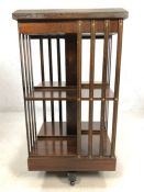 Revolving bookcase with inlaid detailing to top, approx approx 46cm x 46cm x 85cm