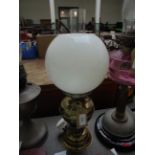 Converted electric brass oil lamp with domed clouded glass shade