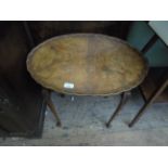 Oval topped pie crust wedged side table in mixed woods on tapering spud feet