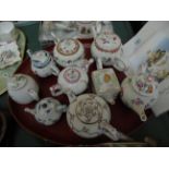 9 various teapots all being part of the Victoria and Albert Museum porcelain tea pot collection