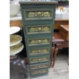 Green painted nest of 7 small storage drawers, hand painted floral decoration
