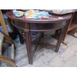 Circular topped carved side table on 4 reeded legs united by cross stretchers