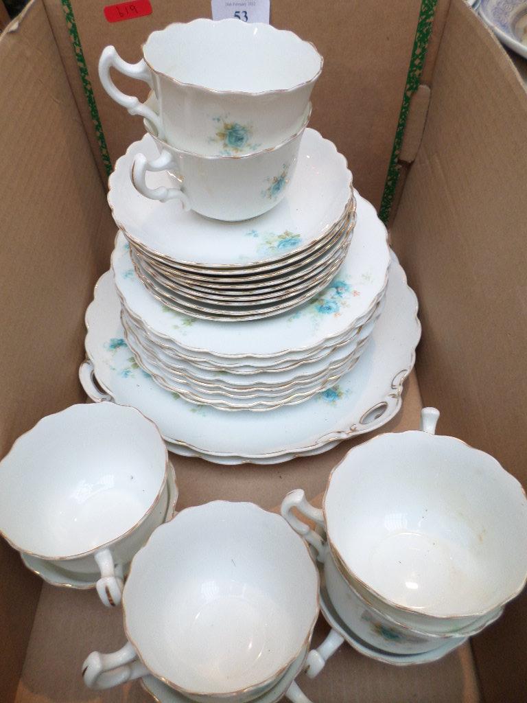 Part white ground bone china tea service decorated sprays of blue roses (28 pieces)