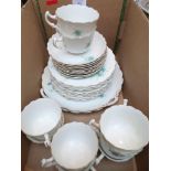 Part white ground bone china tea service decorated sprays of blue roses (28 pieces)