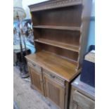 Oak display cabinet, the upper with 2 open display shelves and carved frieze above