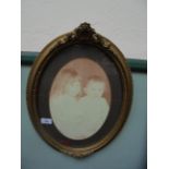 Oval picture frame in ornate beaded gilt frame