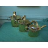 3 graduated brass lidded water jugs