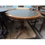 Circular topped mahogany side table inset gilt and green tooled leather top on 4 splayed claw feet