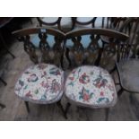 Pair of round backed Ercol dining chairs each with carved vertical splats to back each with loose