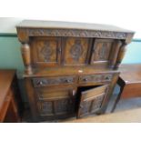 Early carved oak court cupboard the upper portion with break front inset double carved cupboard and