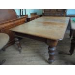 Mahogany double drop leaf sofa table on plain circular turned legs on brass castors (approx.