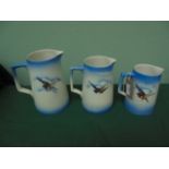 Set of 3 blue ground graduated jugs inset transfers of birds and butterflies