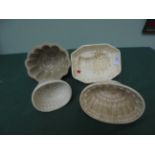4 cream and grey ground jelly moulds,