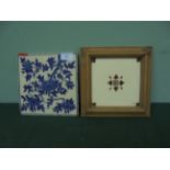 Framed brown and cream late Victorian wall tile and another blue and white patterned tile of