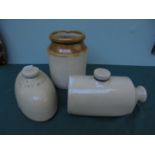 2 stone hot water bottles and a stone storage jar