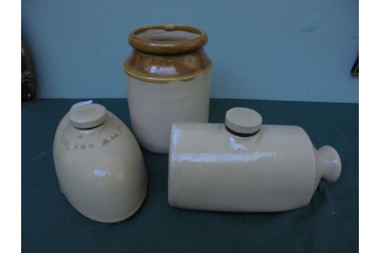 2 stone hot water bottles and a stone storage jar