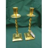 Pair of twist stemmed brass candlesticks each on square base