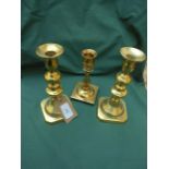 Pair of brass candlesticks and another