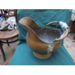 Ornate copper helmet shaped kettle with brass fittings,