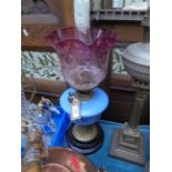 Ornate oil lamp with blue glass bowl,