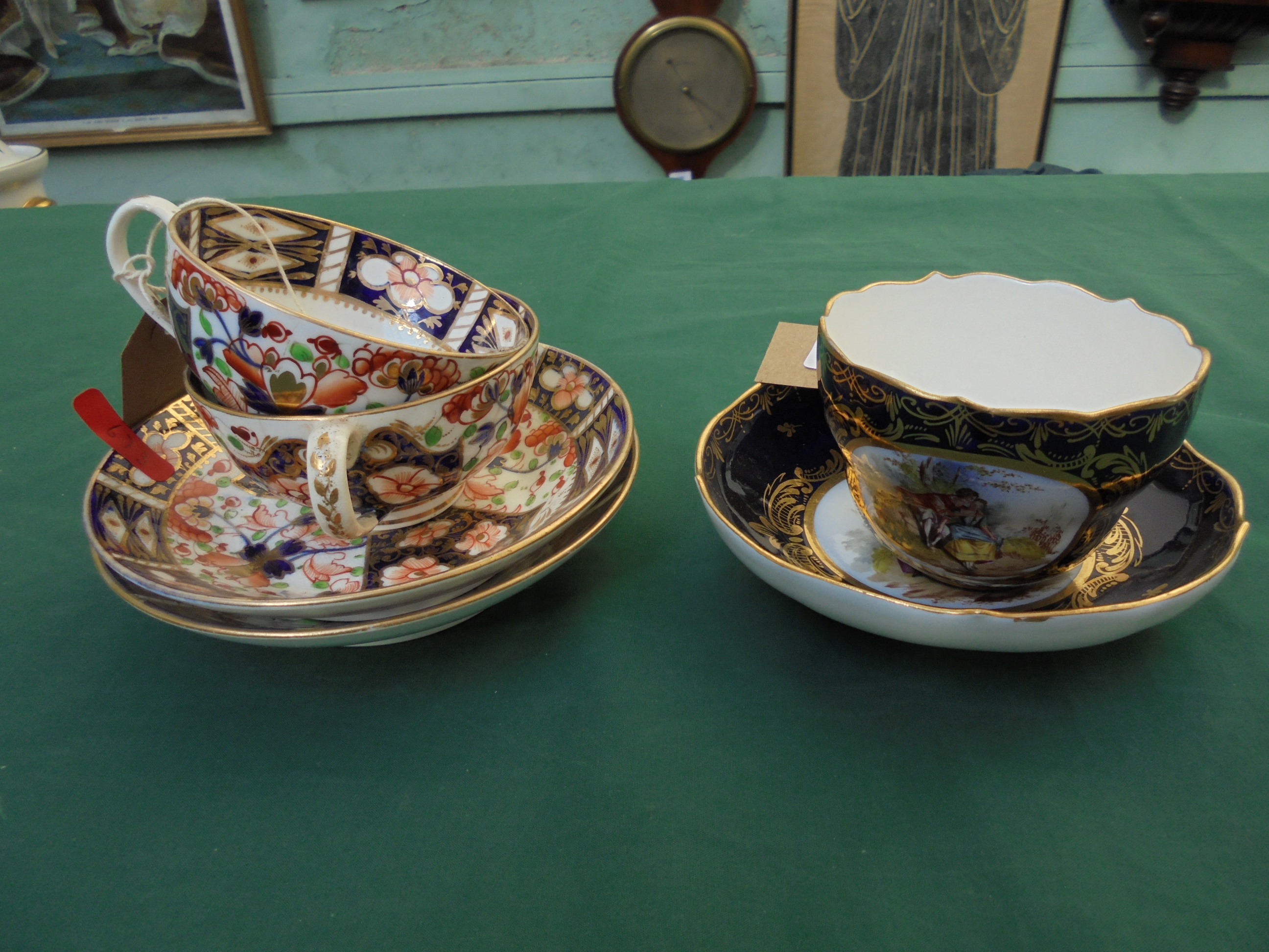 Pair of early Crown Derby cups and saucers and a cobalt blue ground Meissen cup and saucer inset