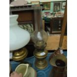 Brass oil lamp with shaped bulbous flue together with Famous Grouse Fine Scotch Whisky water jug