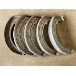 Four newly cast alloy Invicta brake shoes plus an original example.