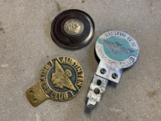 Two Austin 10 Drivers Club badges plus a bakelite backed St. Christopher tax disc holder.