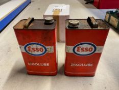 Two gallon cans of Essolube oil.