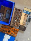 A selection of boxed precision tools, including taps and dies.