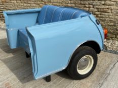 A stylish blue upholstered seat formed as the rear section of a Mini, made for the Goodwood Revival,