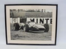 A framed and glazed photograph of Scarfiotti in Ferrari 312, 19 x 15 1/4".