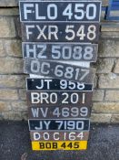 A display board covered in old number plates.