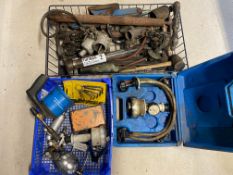 A crate of parts and equipment, a radiator leak checker tool and a tray of tools including a spray