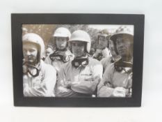 A framed and glazed driver's briefing photograph, depicting Bruce mcLaren, Jim Hall, Trevor