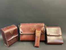 Four leather cased motorist's accessory kits including a torch tool kit.
