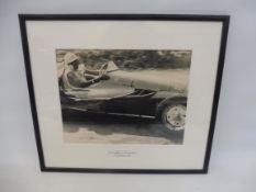 A framed and glazed photograph by Alan Smith of Stirling Moss in the Cooper-Alta, 18 x 15 3/4".