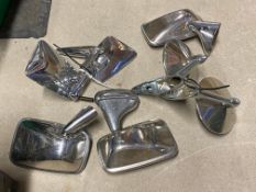 A collection of seven chrome wing/door mounted exterior rear view mirrors.