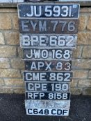 A display board covered in old number plates.