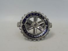 A Rotary International blue enamel and chrome plated car badge.