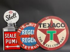 A reproduction Shell enamel sign, a handpainted Texaco sign and a circular Continental road sign