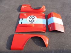 A Triumph TR4A fibreglass race bonnet, boot and pair of front wings.