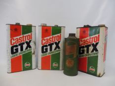 A Fina Green five gallon drum and three Castrol GTX gallon cans plus a Castrol cardboard quart can.